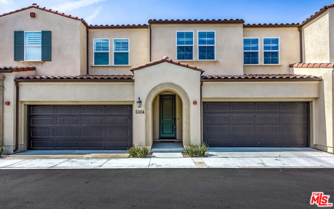 a front view of a house with a garage