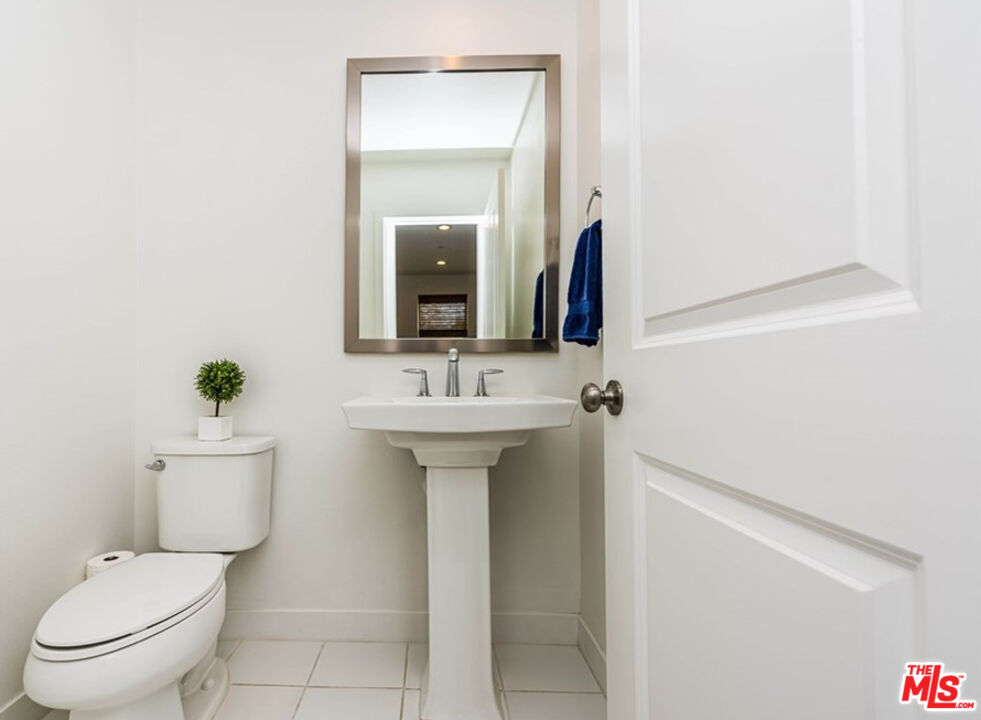 5304 Harvard Way Cypress, CA 90630 - Photo 11 of 29 a bathroom with a toilet sink and mirror