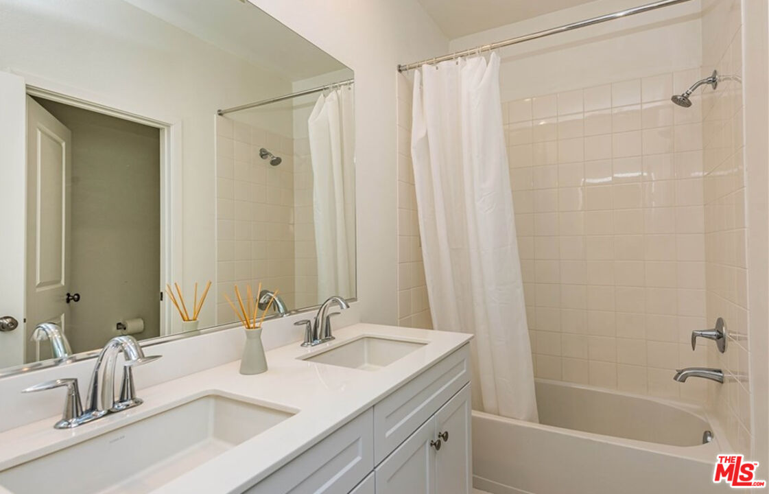 5304 Harvard Way Cypress, CA 90630 - Photo 19 of 29 a bathroom with a double vanity sink and a mirror