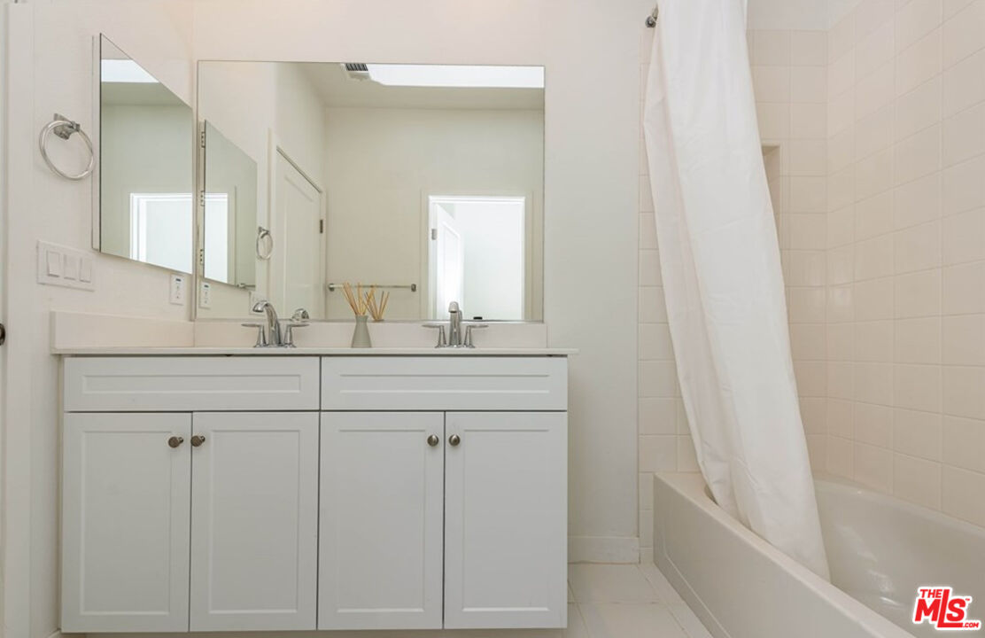 5304 Harvard Way Cypress, CA 90630 - Photo 20 of 29 a bathroom with a double vanity sink and a mirror
