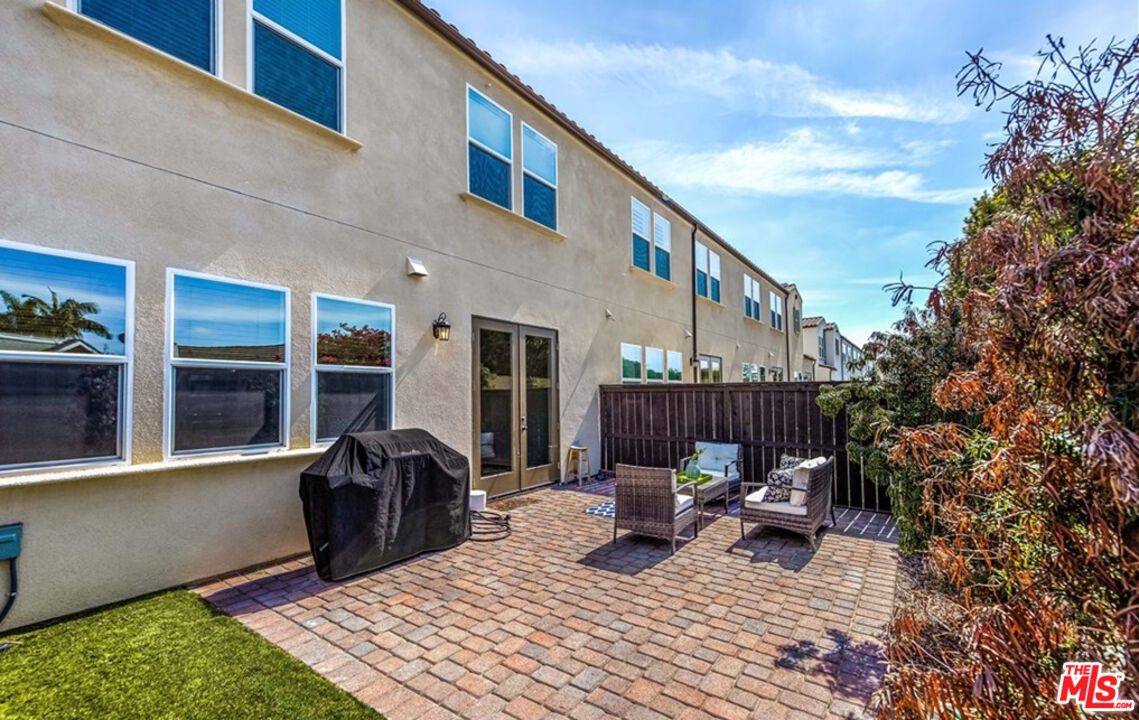 5304 Harvard Way Cypress, CA 90630 - Photo 27 of 29 a view of a patio with a table and chairs and potted plants