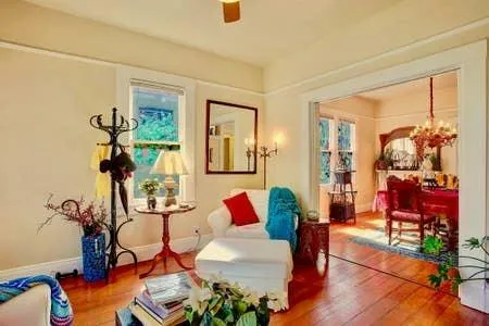 a living room with furniture and a potted plant