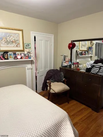 a bedroom with a bed and a large mirror