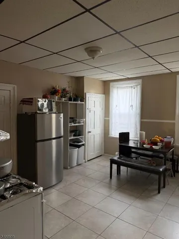 a kitchen with a refrigerator and a stove top open