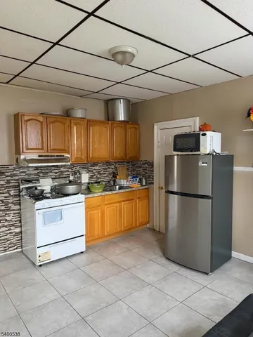 a kitchen with refrigerator and cabinets