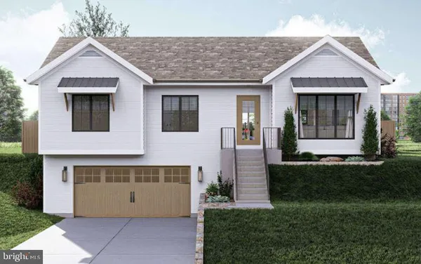 a front view of a house with a garden and yard