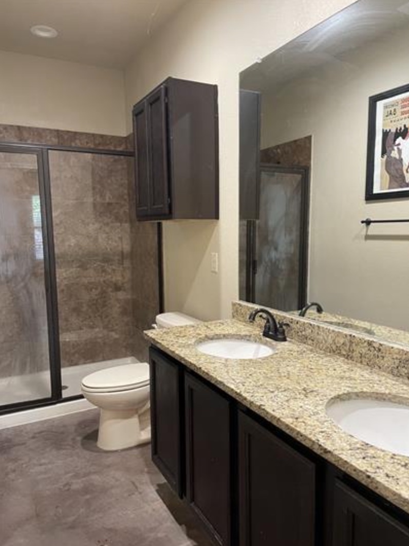 601 Jack Rabbit Lane, Unit B Buda, TX 78610 - Photo 9 of 10 a bathroom with a granite countertop sink toilet and shower