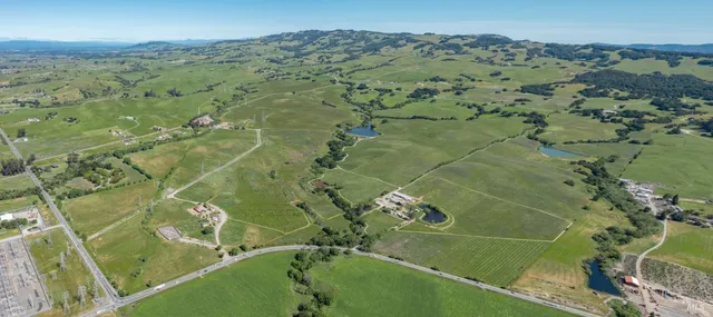 an aerial view of a residential houses with outdoor space