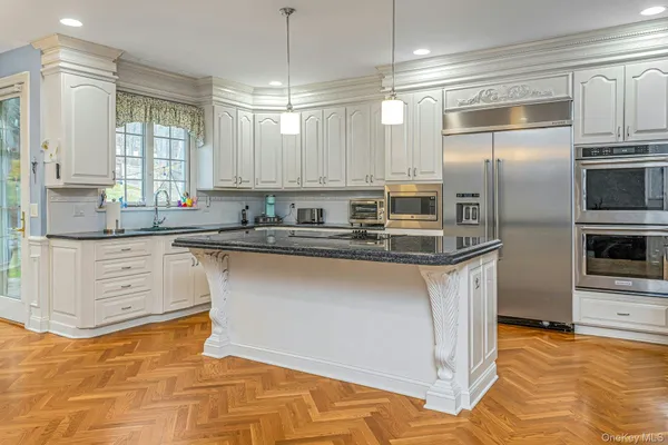 a kitchen with stainless steel appliances granite countertop a sink and cabinets