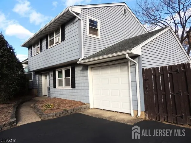 a view of room with wooden floor and windows
