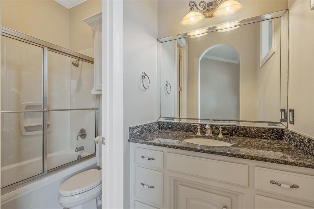 20389 County Road 178 Flint, TX 75762 - Photo 19 of 40 Bathroom featuring a vanity with a dark granite countertop, undermount sink, and white cabinetry