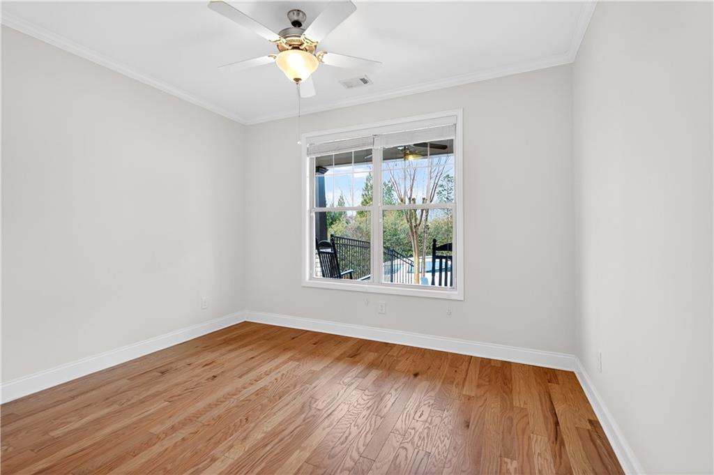 310 Pepperwood Way Canton, GA 30114 - Photo 29 of 54 an empty room with wooden floor and windows