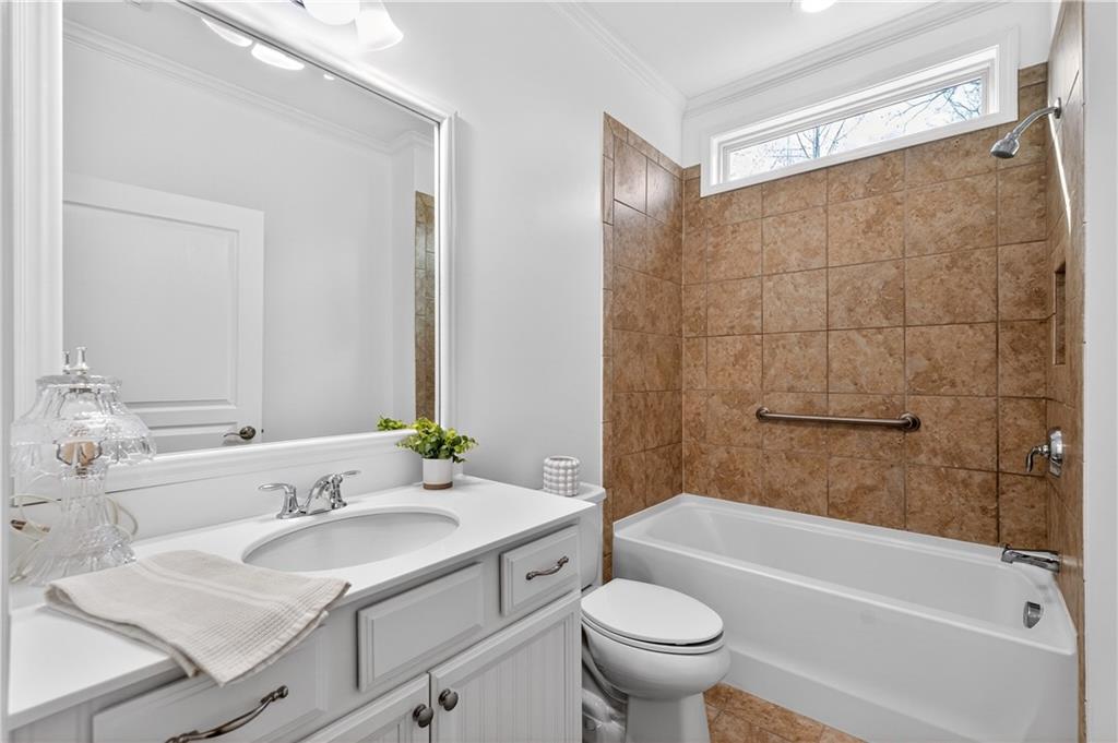 310 Pepperwood Way Canton, GA 30114 - Photo 30 of 54 a bathroom with a granite countertop sink toilet and shower
