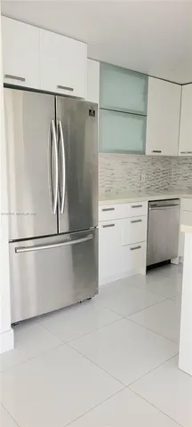 a kitchen with stainless steel appliances a refrigerator and cabinets