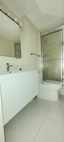 a bathroom with a glass shower door