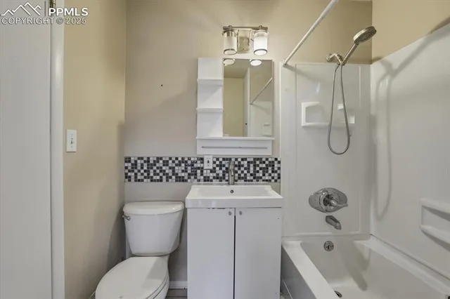 a bathroom with a toilet sink shower and mirror