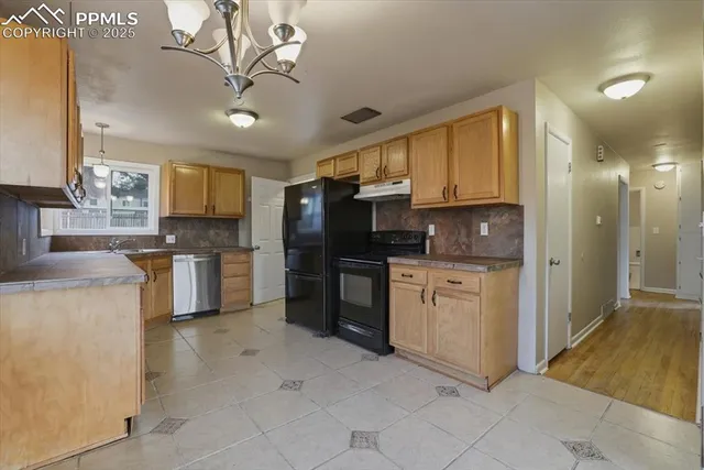 a kitchen with granite countertop cabinets and steel stainless steel appliances
