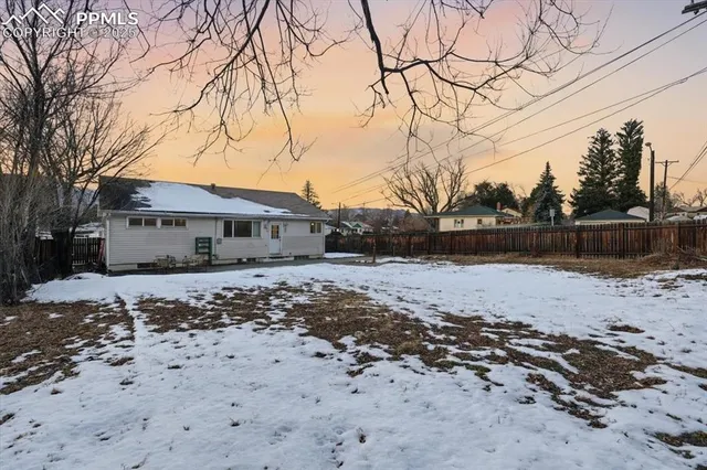 a backyard of a house with wooden fence