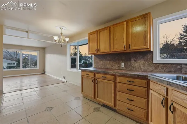 a kitchen with granite countertop a sink cabinets and window