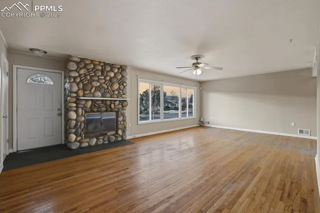 wooden floor in an empty room with a fireplace
