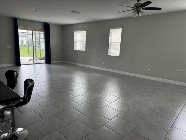 a view of a livingroom with furniture and a window