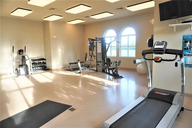 a dining room with wooden floor and large windows