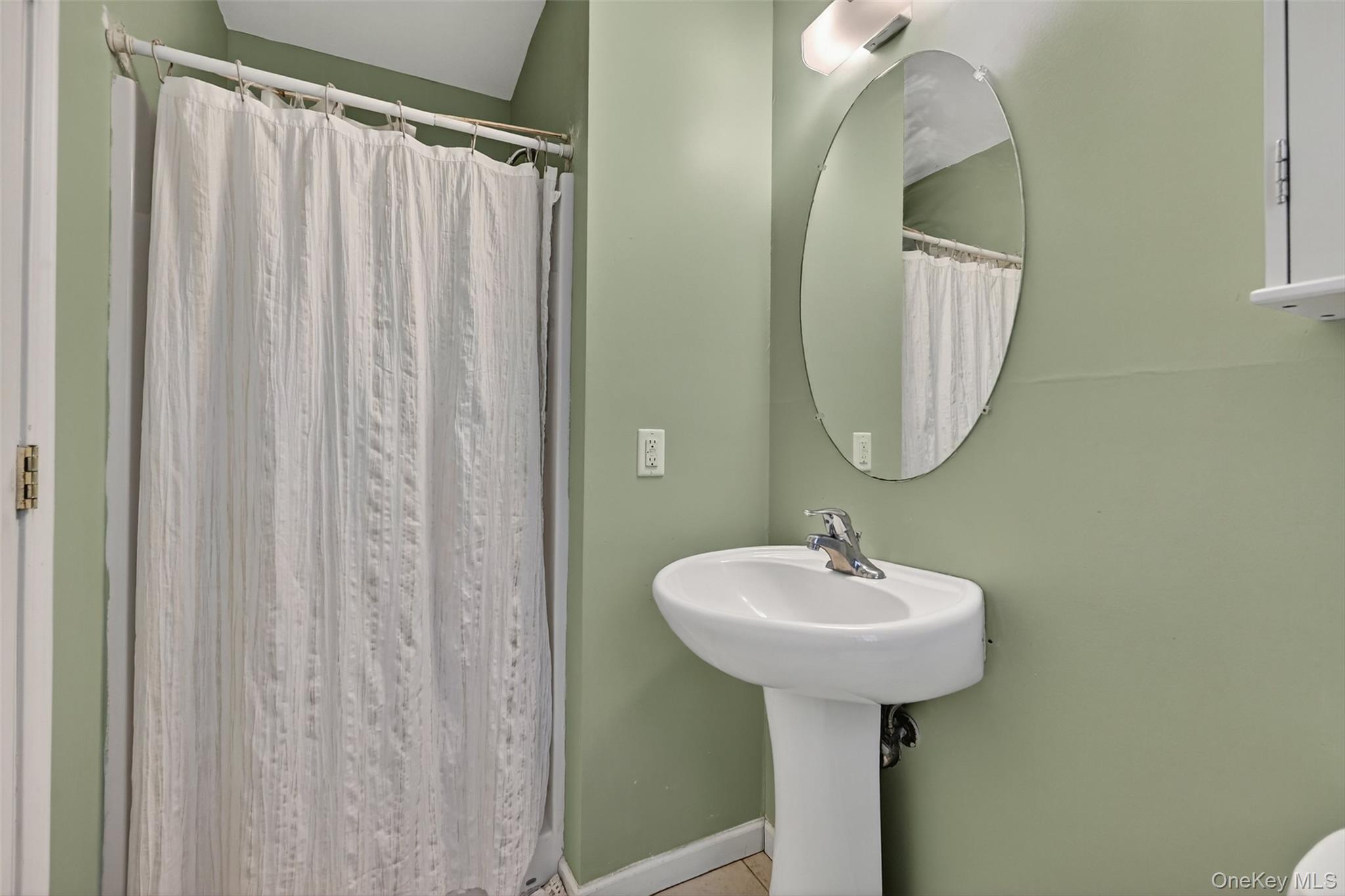 913 Silver Lake Sctn Road Middletown, NY 10941 - Photo 23 of 29 a bathroom with a sink a mirror and a window