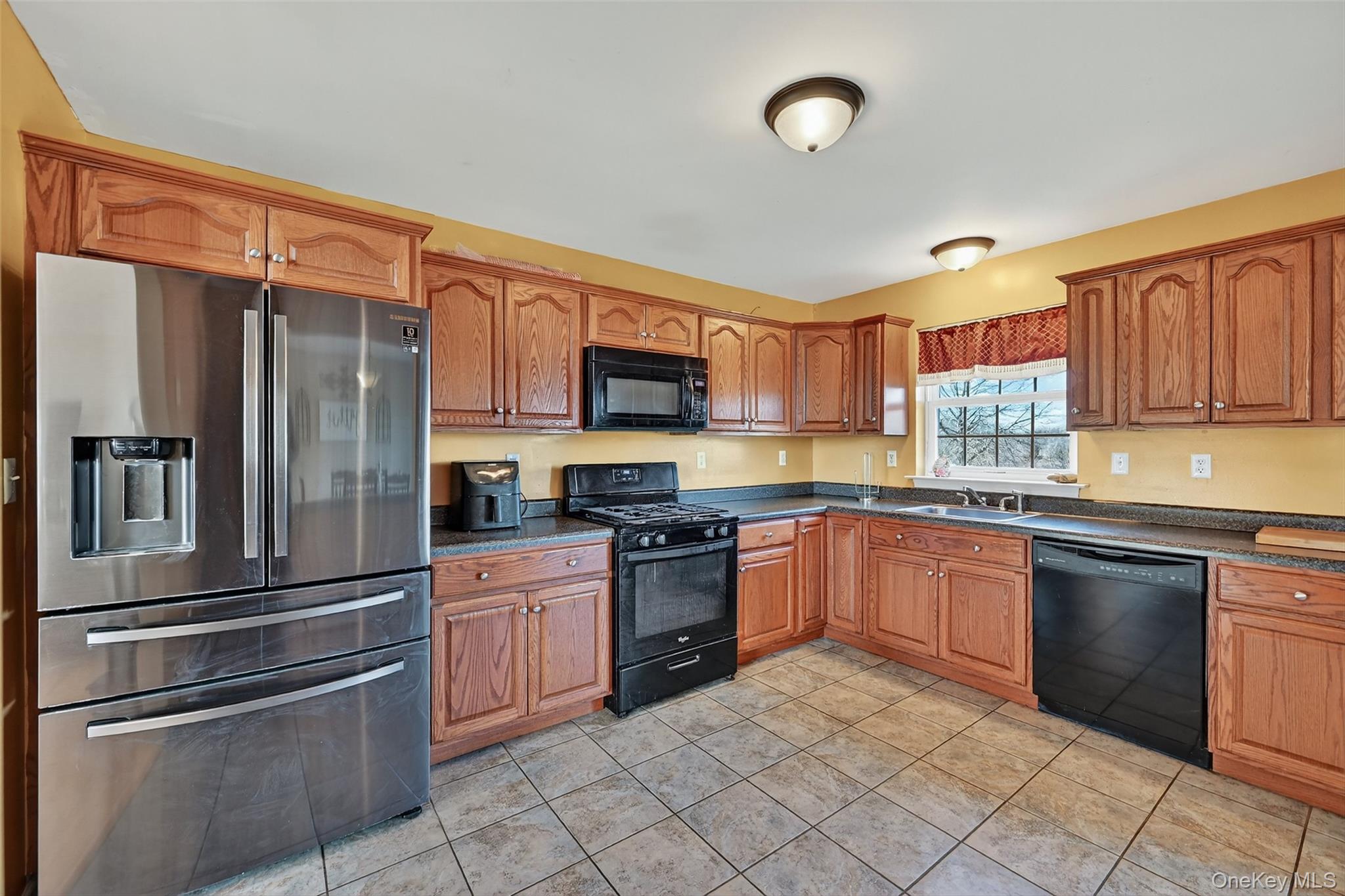 913 Silver Lake Sctn Road Middletown, NY 10941 - Photo 9 of 29 a kitchen with granite countertop stainless steel appliances and wooden cabinets