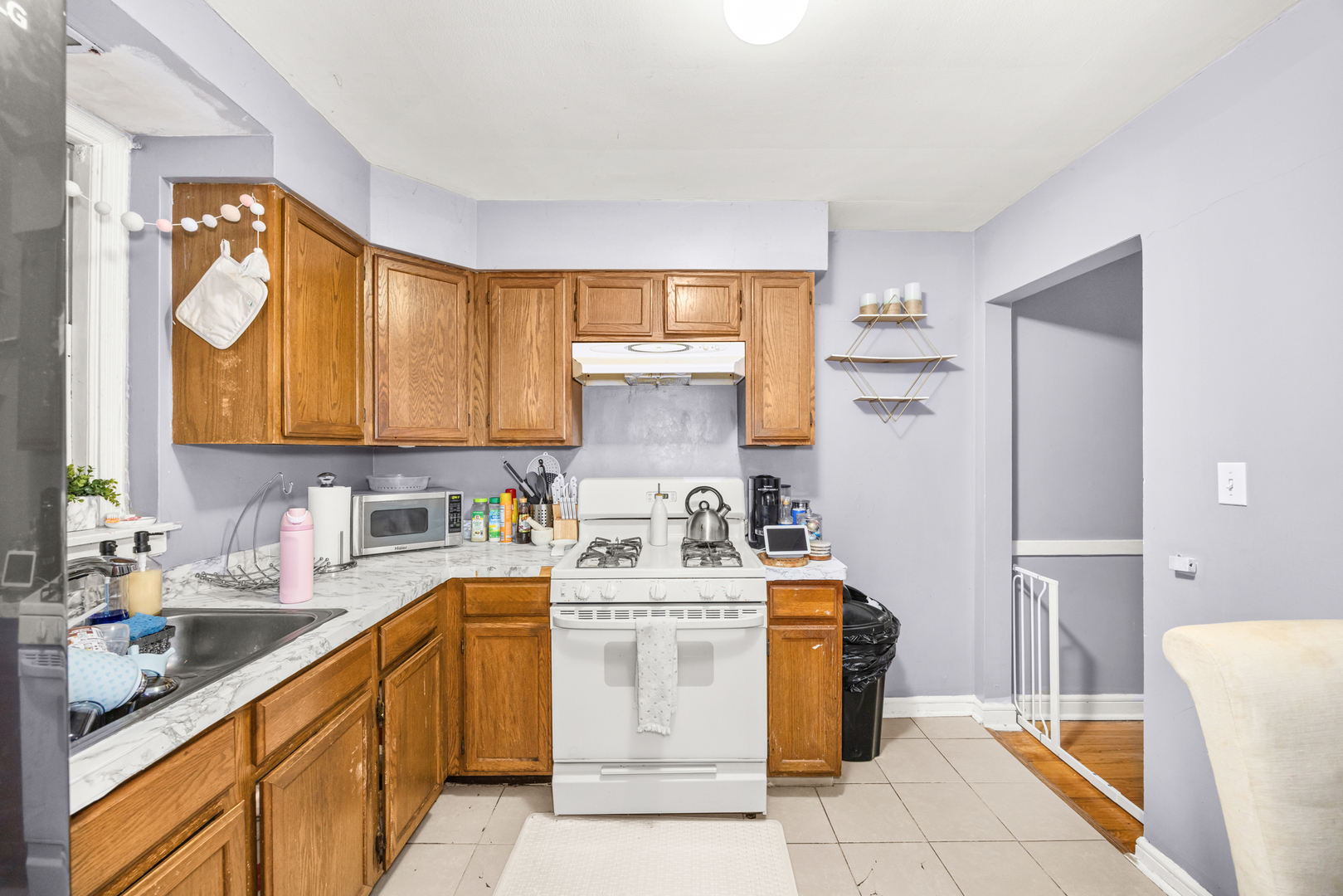 1406 Brummel Street Evanston, IL 60202 - Photo 16 of 20 a kitchen with stainless steel appliances granite countertop a stove a sink and a refrigerator