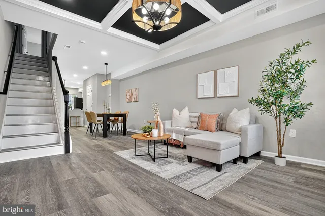 a living room with furniture and a potted plant
