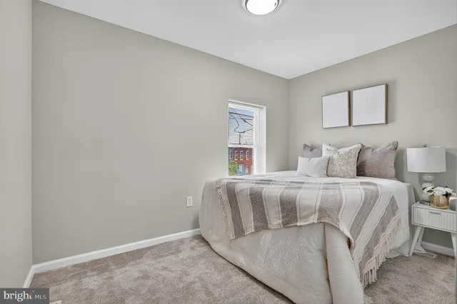 a bedroom with a bed and a night stand