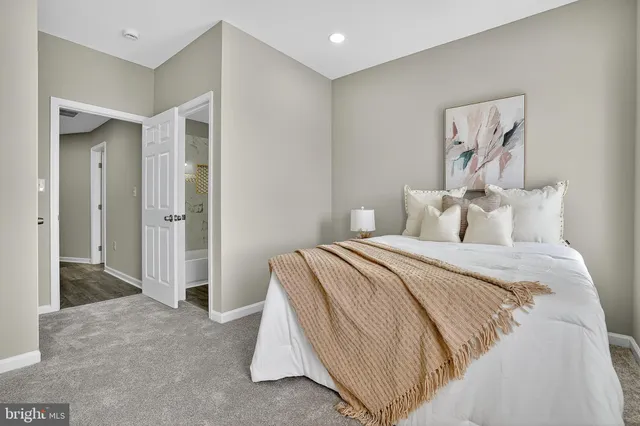 a bedroom with a bed and a potted plant