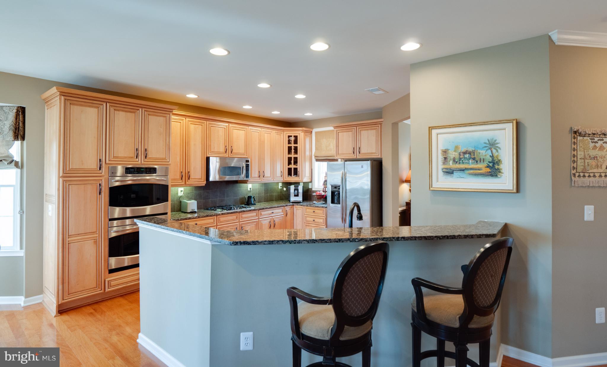 23152 Evergreen Ridge Drive Ashburn, VA 20148 - Photo 19 of 72 Modern kitchen with warm wood accents.