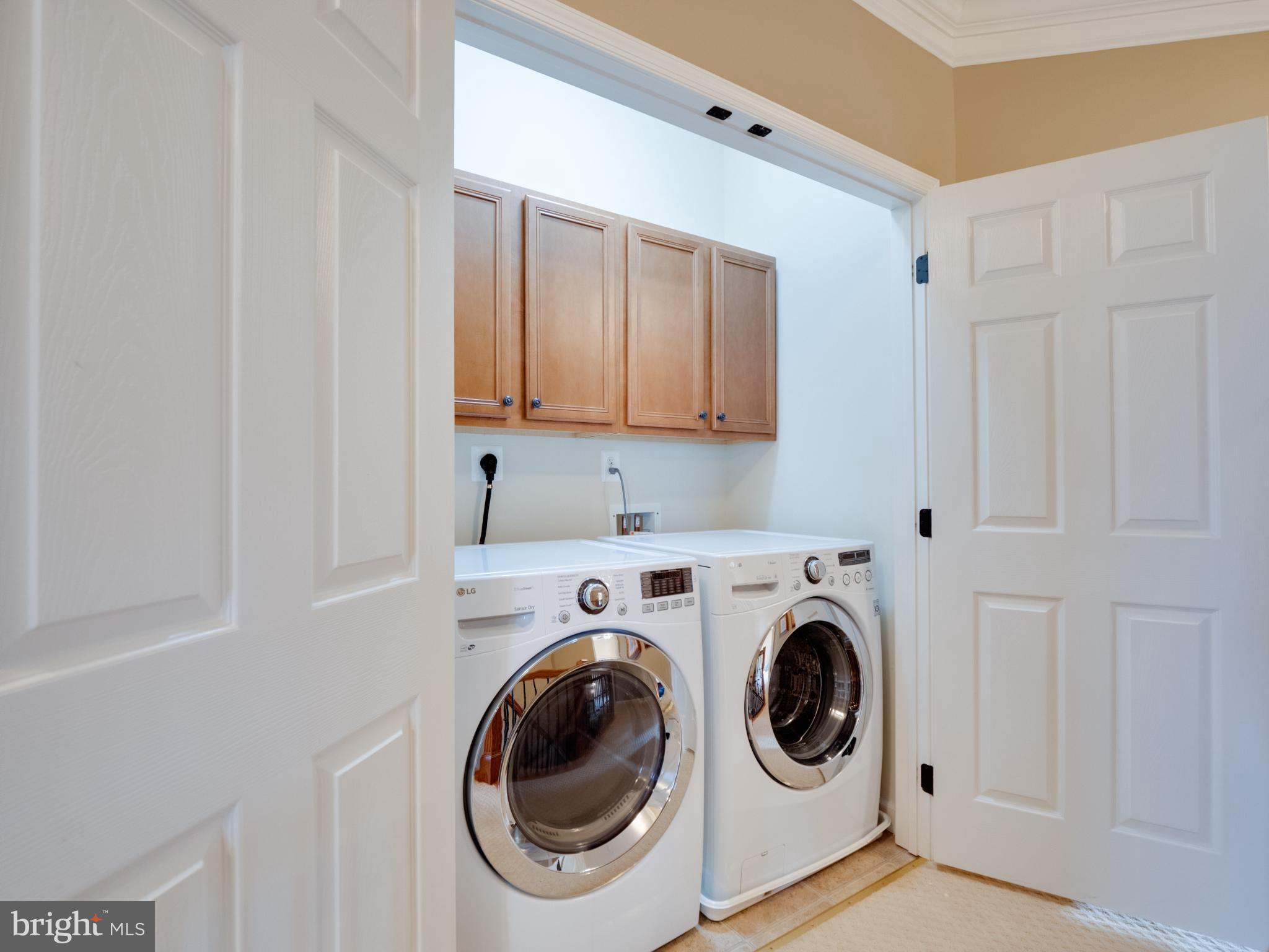 23152 Evergreen Ridge Drive Ashburn, VA 20148 - Photo 50 of 72 Modern laundry space with sleek appliances.