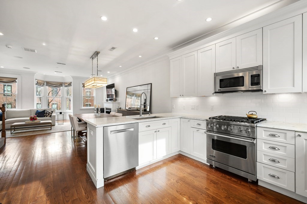 212 West Springfield Street, Unit 2 Boston, MA 02118 - Photo 11 of 41 a kitchen with stainless steel appliances granite countertop a stove and a wooden floors