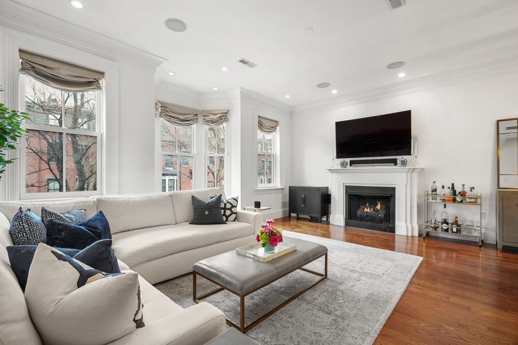 212 West Springfield Street, Unit 2 Boston, MA 02118 - Photo 2 of 41 a living room with furniture a fireplace and a flat screen tv