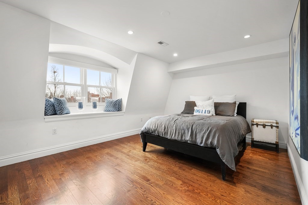 212 West Springfield Street, Unit 2 Boston, MA 02118 - Photo 26 of 41 a bedroom with a large bed and wooden floor