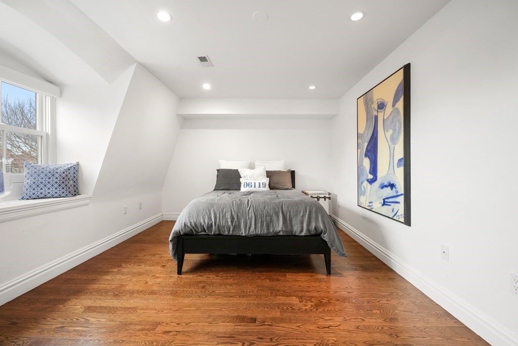 212 West Springfield Street, Unit 2 Boston, MA 02118 - Photo 27 of 41 a bedroom with a bed and wooden floor
