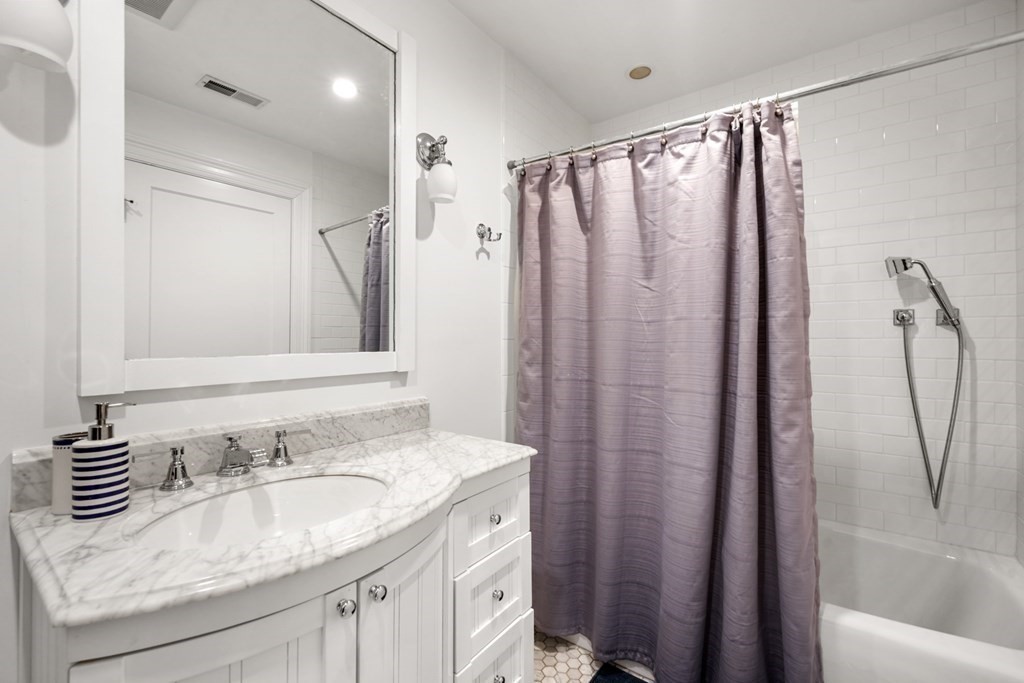 212 West Springfield Street, Unit 2 Boston, MA 02118 - Photo 30 of 41 a bathroom with a granite countertop sink and a mirror