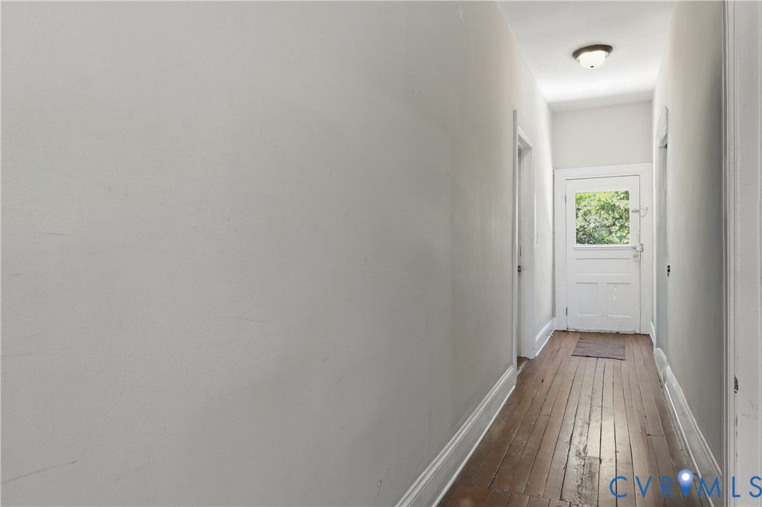 3405 East Broad Rock Road Richmond, VA 23224 - Photo 15 of 22 upstairs hallway with hardwood floors and door lea