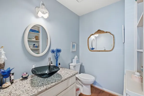 a bathroom with a toilet a sink and a mirror