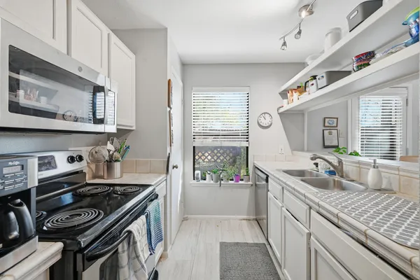 a kitchen that has a sink and a stove