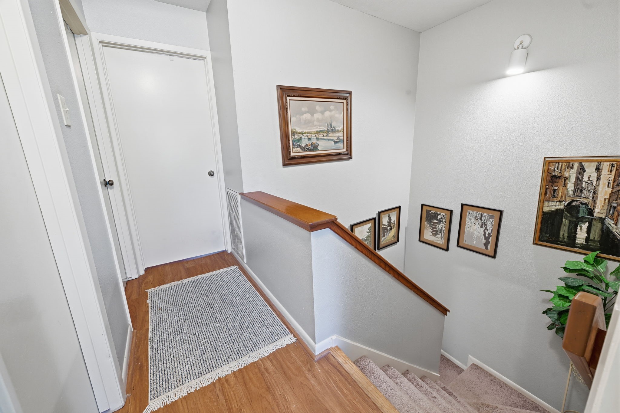 4 Sawmill Grove Lane Spring, TX 77380 - Photo 18 of 27 a hallway with wooden floor and stairs