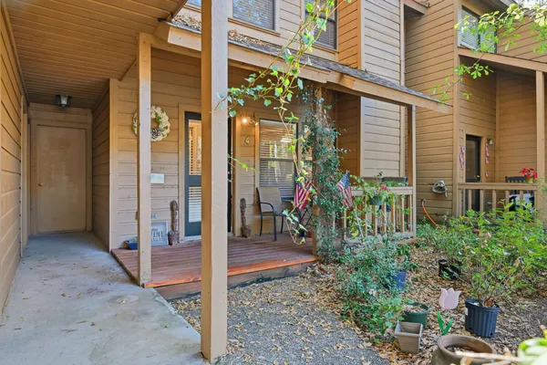 a view of a house with a potted plant and floor to ceiling window