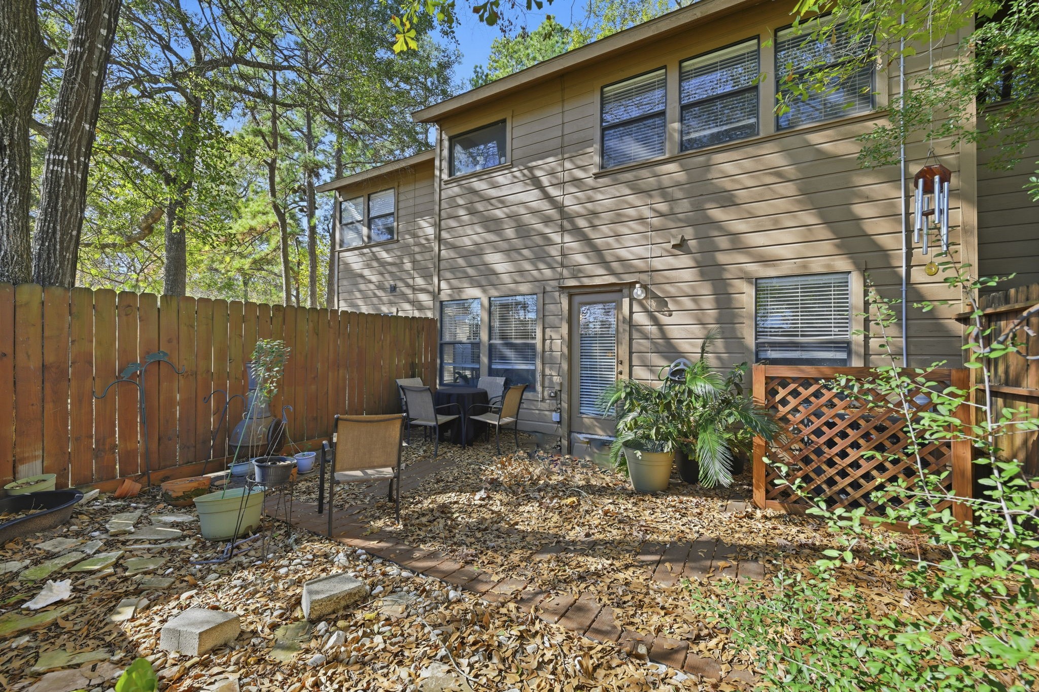 4 Sawmill Grove Lane Spring, TX 77380 - Photo 25 of 27 a backyard of a house with potted plants and covered with trees