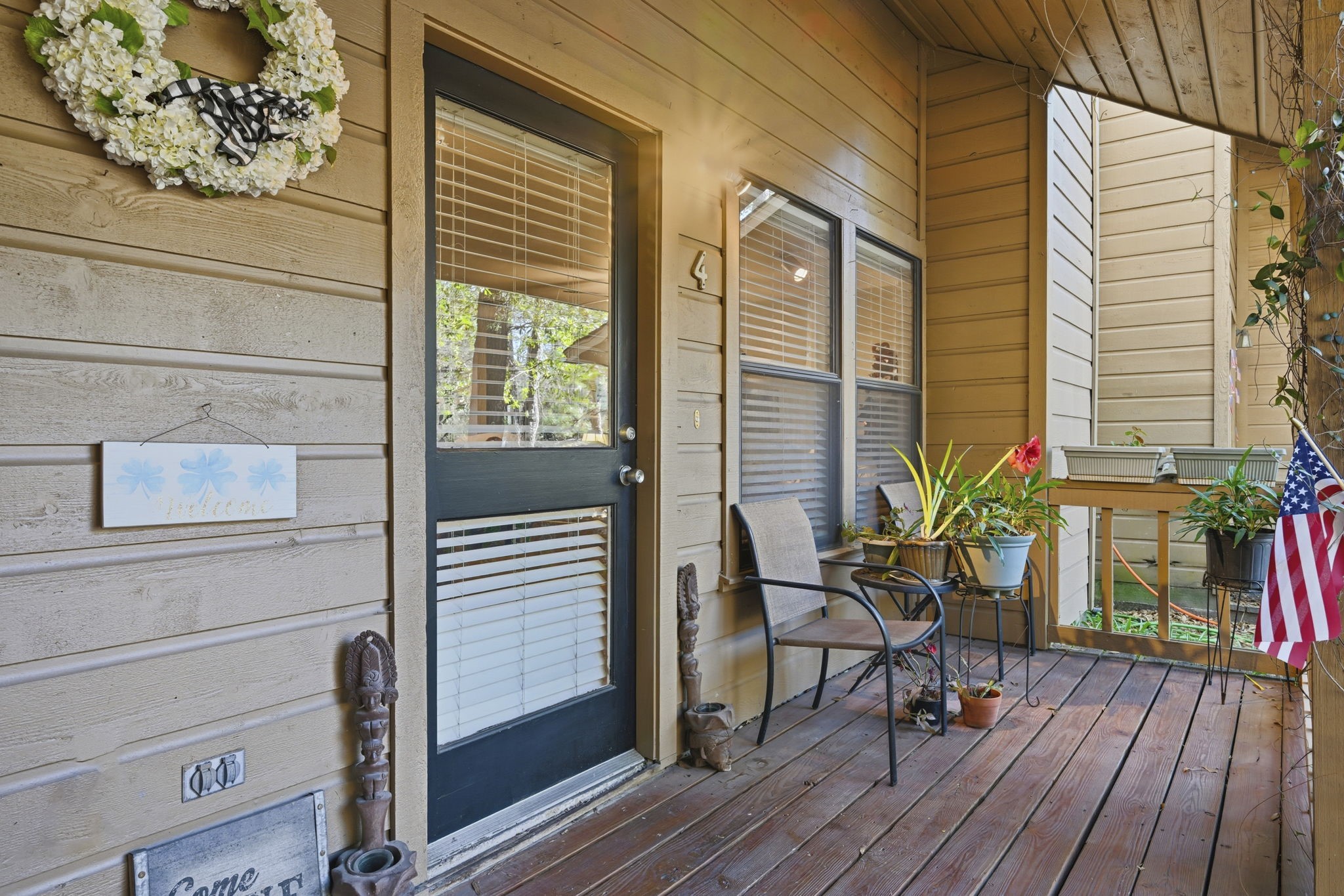 4 Sawmill Grove Lane Spring, TX 77380 - Photo 3 of 27 a porch with chairs and wooden floor