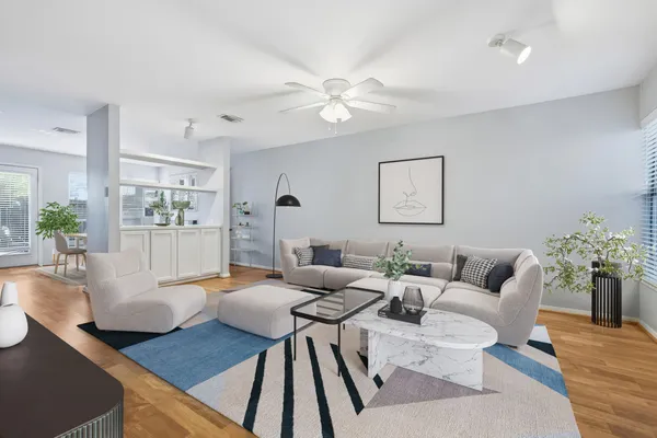 a living room with furniture and a chandelier