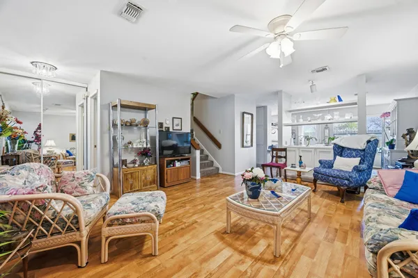 a living room with furniture and a chandelier