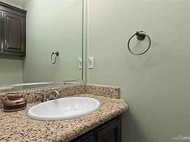 2709 Cardinal Avenue McAllen, TX 78504 - Photo 15 of 19 a bathroom with a granite countertop sink and mirror