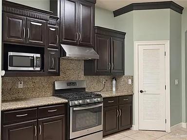 2709 Cardinal Avenue McAllen, TX 78504 - Photo 8 of 19 a kitchen with granite countertop stainless steel appliances and wooden cabinets